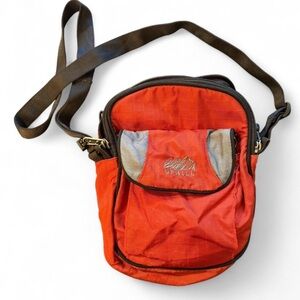 UPHILL travel crossbody, unisex. Zips all around and opens to travel organizers